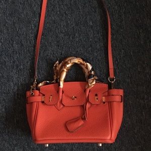 Orange shoulder and handbag.